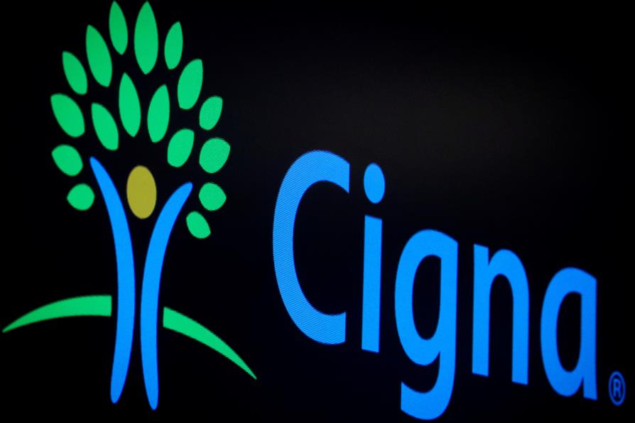 A screen displays the logo for Cigna Corp on the floor at the New York Stock Exchange (NYSE) in New York, U.S., July 16, 2019. REUTERS/Brendan McDermid/File Photo