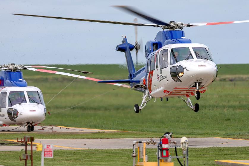 A helicopter carrying evacuated workers from oil production platforms lands ahead of Tropical Storm Cristobal, at Bristow Galliano Heliport in Galliano, Louisiana, U.S. June 6, 2020.  REUTERS/Jo<em></em>nathan Bachman/File Photo