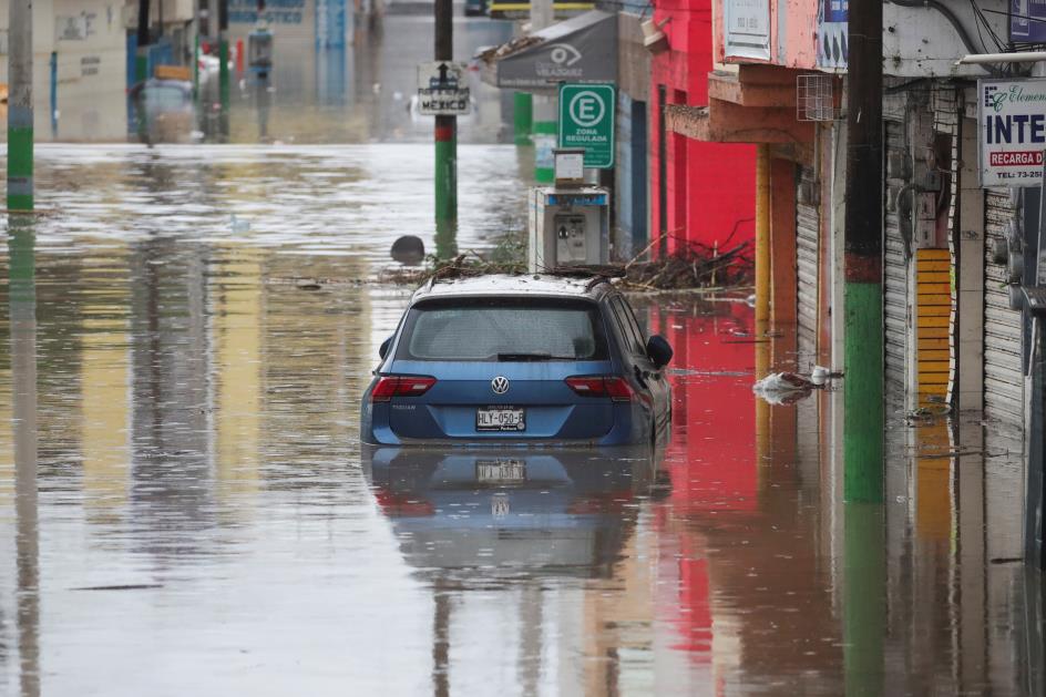 A partially submerged car is seen on a flooded street after heavy rainfall during Monday's night that left people dead, injured and damaged cars and infrastructure, in Tula de Allende, on the outskirts of Mexico City, Mexico September 7, 2021. REUTERS/Henry Romero