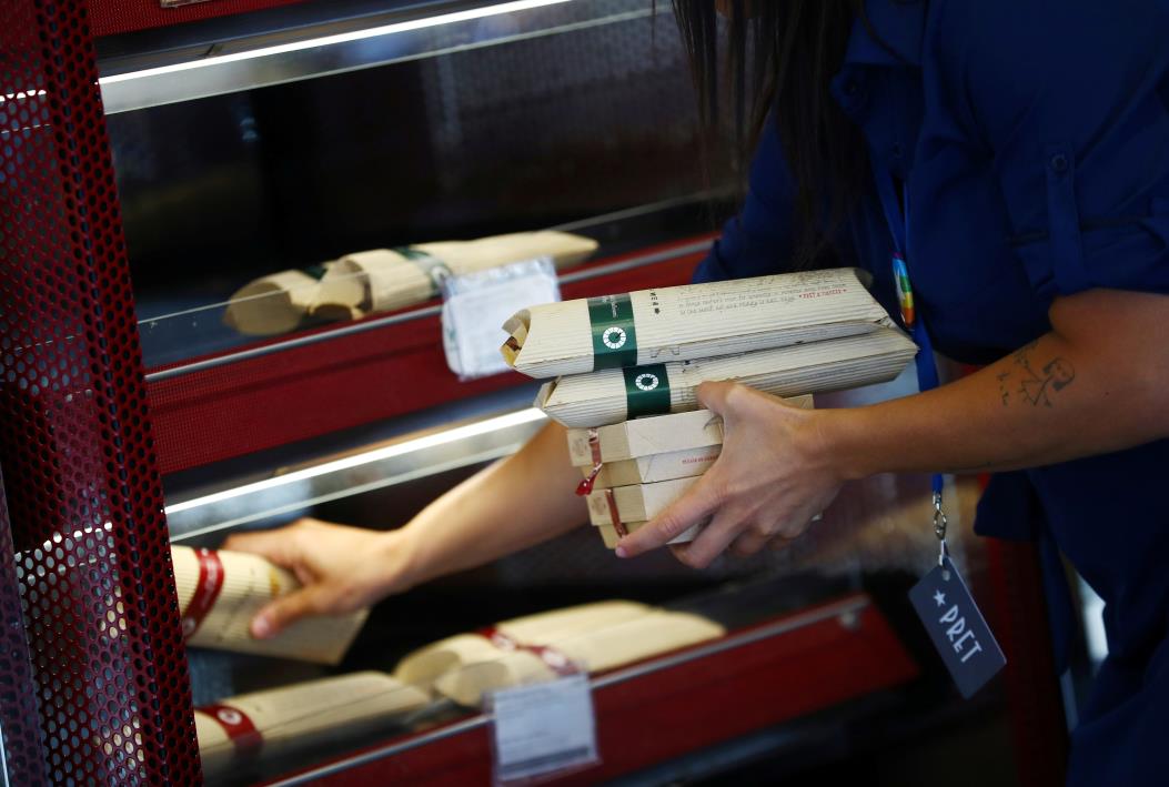 A worker puts out food at Pret a Manger in New Cavendish Street, following the outbreak of the coro<em></em>navirus disease (COVID-19), London, Britain, June 1, 2020. REUTERS/Hannah McKay