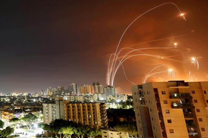 Streaks of light are seen as Israel's Iron Dome anti-missile system intercepts rockets launched from the Gaza Strip towards Israel, as seen from Ashkelon, Israel, May 12. REUTERS/Amir Cohen