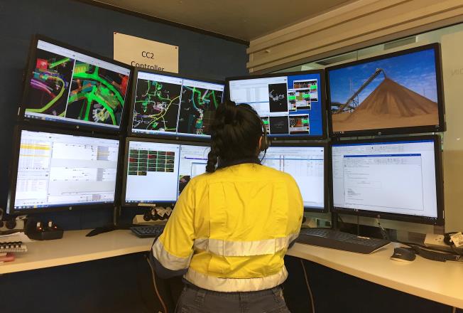 A worker for Australia's Fortescue text<em></em>areals Group (FMG) watches screens that mo<em></em>nitor auto<em></em>nomous vehicles at FMG's Chichester Hub iron ore operations, which includes the Christmas Creek iron ore mine, in the Pilbara region, located south-east of the coastal town of Port Hedland in Western Australia, November 29, 2018. Picture taken November 29, 2018.      REUTERS/Melanie Burton