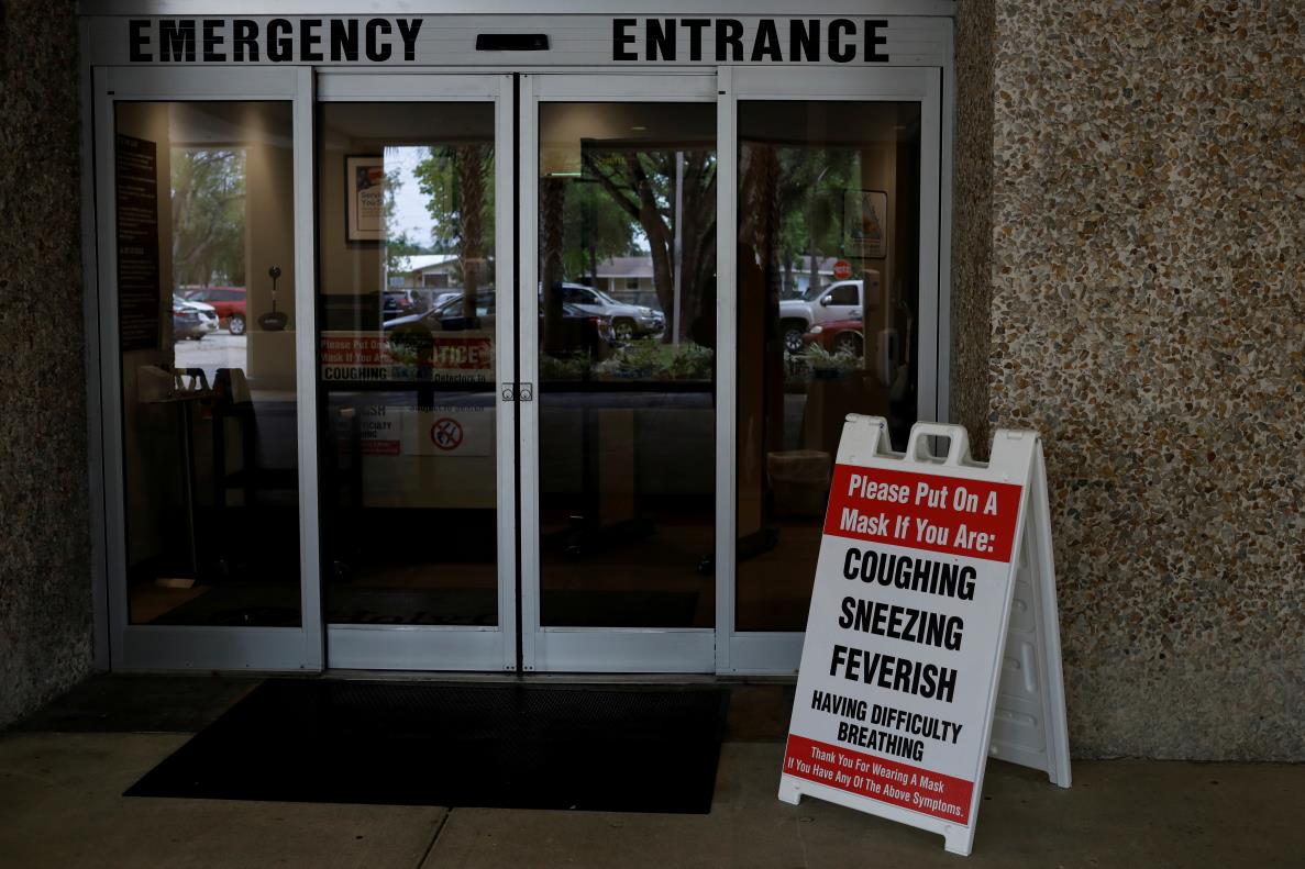 A banner asking patients to wear a mask is seen at the entrance of the ER area at Holy Cross Hospital, amid an outbreak of coro<em></em>navirus disease (COVID-19), in Fort Lauderdale, Florida, U.S., April 20, 2020. REUTERS/Marco Bello