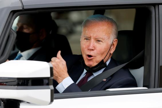 U.S. President Joe Biden gestures after driving a Hummer EV during a tour at the General Motors 'Factory ZERO' electric vehicle assembly plant in Detroit, Michigan, U.S. November 17, 2021. REUTERS/Jo<em></em>nathan Ernst