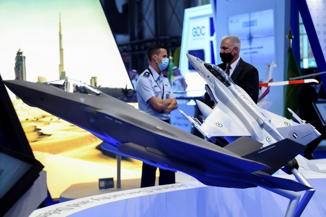 People stand at the Lockheed Martin Aerospace company display during the Dubai Airshow in Dubai, United Arab Emirates, November 15, 2021. REUTERS/Stringer 