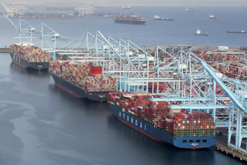 Shipping co<em></em>ntainers are unloaded from ships at a co<em></em>ntainer terminal at the Port of Long Beach-Port of Los Angeles complex in Los Angeles, California, U.S., April 7, 2021. REUTERS/Lucy Nicholson/File Photo