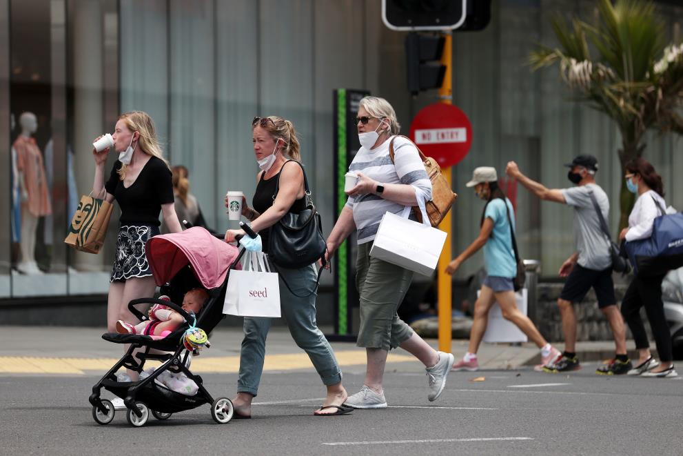 FILE PHOTO:Shoppers walk through a retail district in the wake of coro<em></em>navirus disease (COVID-19) lockdown restrictions being eased in Auckland, New Zealand, November 10, 2021.  REUTERS/Fiona Goodall