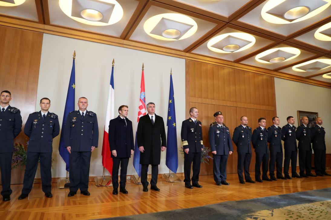 Croatia's President Zoran Milanovic and his French counterpart Emmanuel Macron pose with Croatian pilots, in Zagreb, Croatia, November 25, 2021. REUTERS/Anto<em></em>nio Bronic