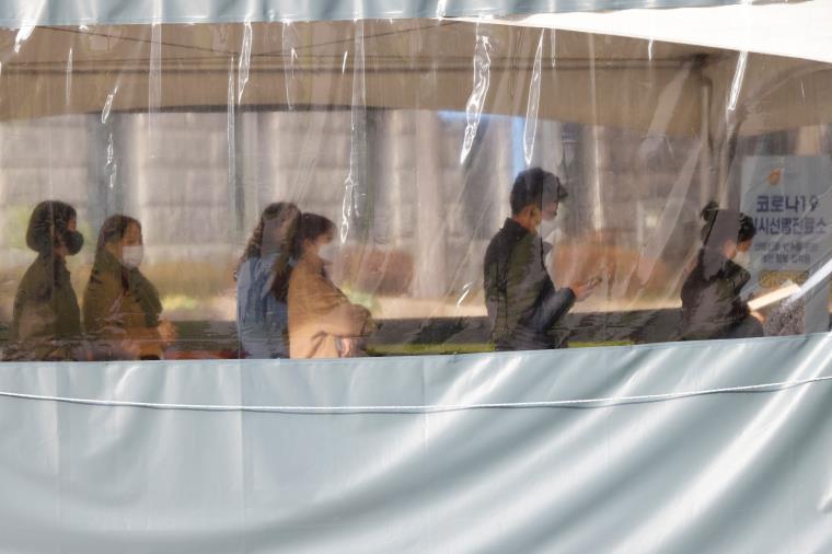 People wait in line to undergo the coro<em></em>navirus test at a temporary testing site set up at City Hall Plaza in Seoul, South Korea, November 29, 2021. REUTERS/Heo Ran  