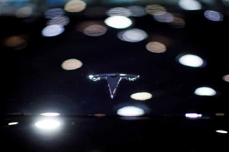 A Tesla logo is seen on the body of its electric vehicle (EV) during a media day for the Auto Shanghai show in Shanghai, China April 20, 2021. REUTERS/Aly Song