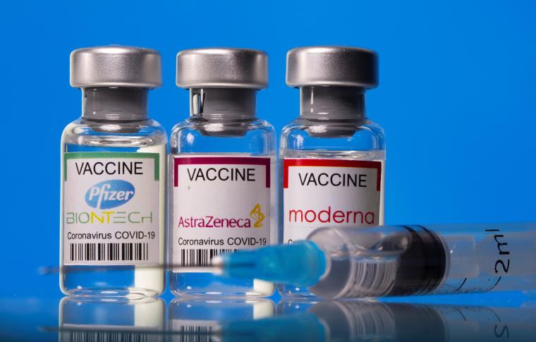 Vials with Pfizer-BioNTech, AstraZeneca, and Moderna coro<em></em>navirus disease (COVID-19) vaccine labels are seen in this illustration picture taken March 19, 2021. REUTERS/Dado Ruvic/Illustration