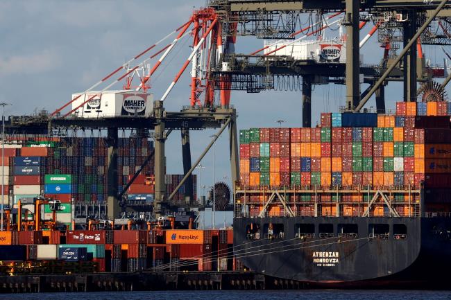 A ship stacked with shipping co<em></em>ntainers is unloaded on a pier at Port Newark, New Jersey, U.S., November 19, 2021. REUTERS/Mike Segar