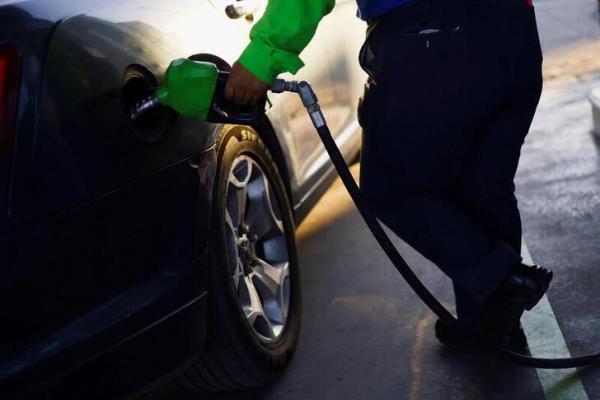 A worker fills a car belo<em></em>nging to a Texas resident, with gasoline at a gas station following increased fuel prices in U.S., in Ciudad Juarez