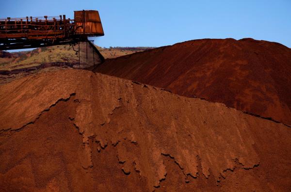 A stacker unloads iron ore o<em></em>nto a pile at a mine located in the Pilbara region of Western Australia