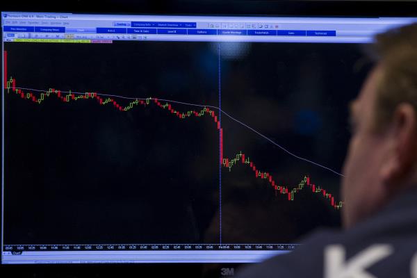 A specialist trader works on the floor of the New York Stock Exchange