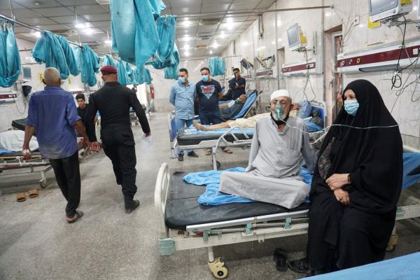 Iraqi people receive oxygen support at a hospital during a sandstorm in Baghdad