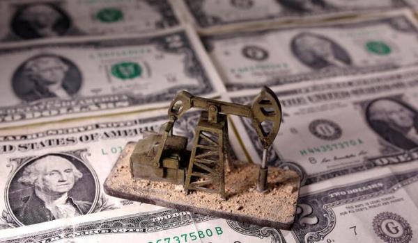 A 3D printed oil pump jack is placed on dollar banknotes in this illustration picture