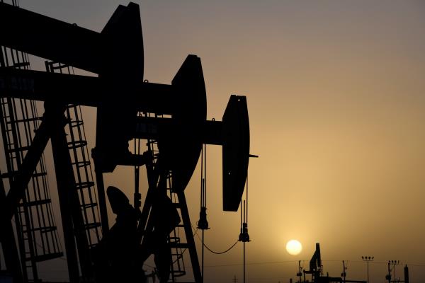 FILE PHOTO - Pump jacks operate at sunset in Midland