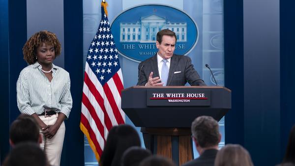 Natio<em></em>nal Security Council spokesperson John Kirby speaks to reporters as White House press secretary Karine Jean-Pierre waits off to the side.