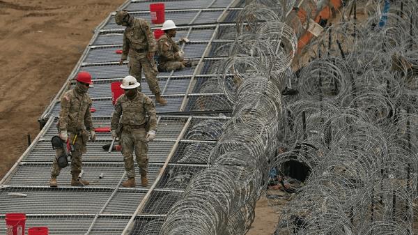 Guardsmen fortify the border along the Rio Grande with co<em></em>ncertina wire, Friday, Feb. 2, 2024, in Eagle Pass, Texas.