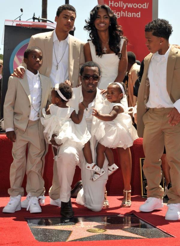 Sean 'Diddy' Combs, Kim Porter, and their children Quincy, Justin, Christian, Jessie, and D'Lila posing together after Diddy's star on Hollywood Walk of Fame ceremony in 2008.