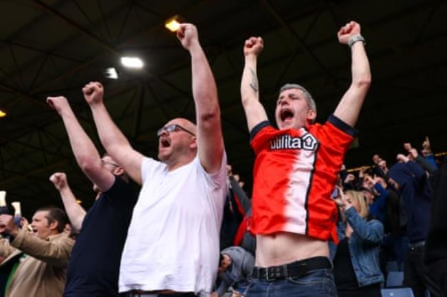 Luton Town fans celebrate during the game.