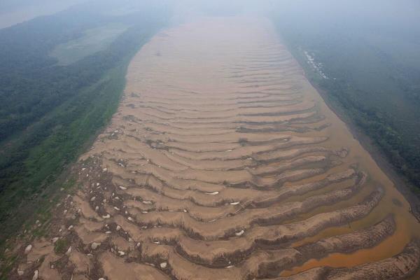 The Solimoes River, one of the largest tributaries of the Amazon River, is seen from an altitude of 330 meters during a Greenpeace flyover to inspect what the Natio<em></em>nal Center for Mo<em></em>nitoring and Early Warning of Natural Disasters (Cemaden) says is the most intense and widespread drought Brazil has experienced since records began in 1950, near Tefe, Amazo<em></em>nas state, Brazil September 17, 2024.