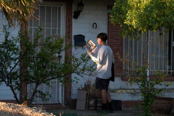 Poder In Action canvasser Andrew Chavez goes door-to-door during a neighborhood canvassing outreach 