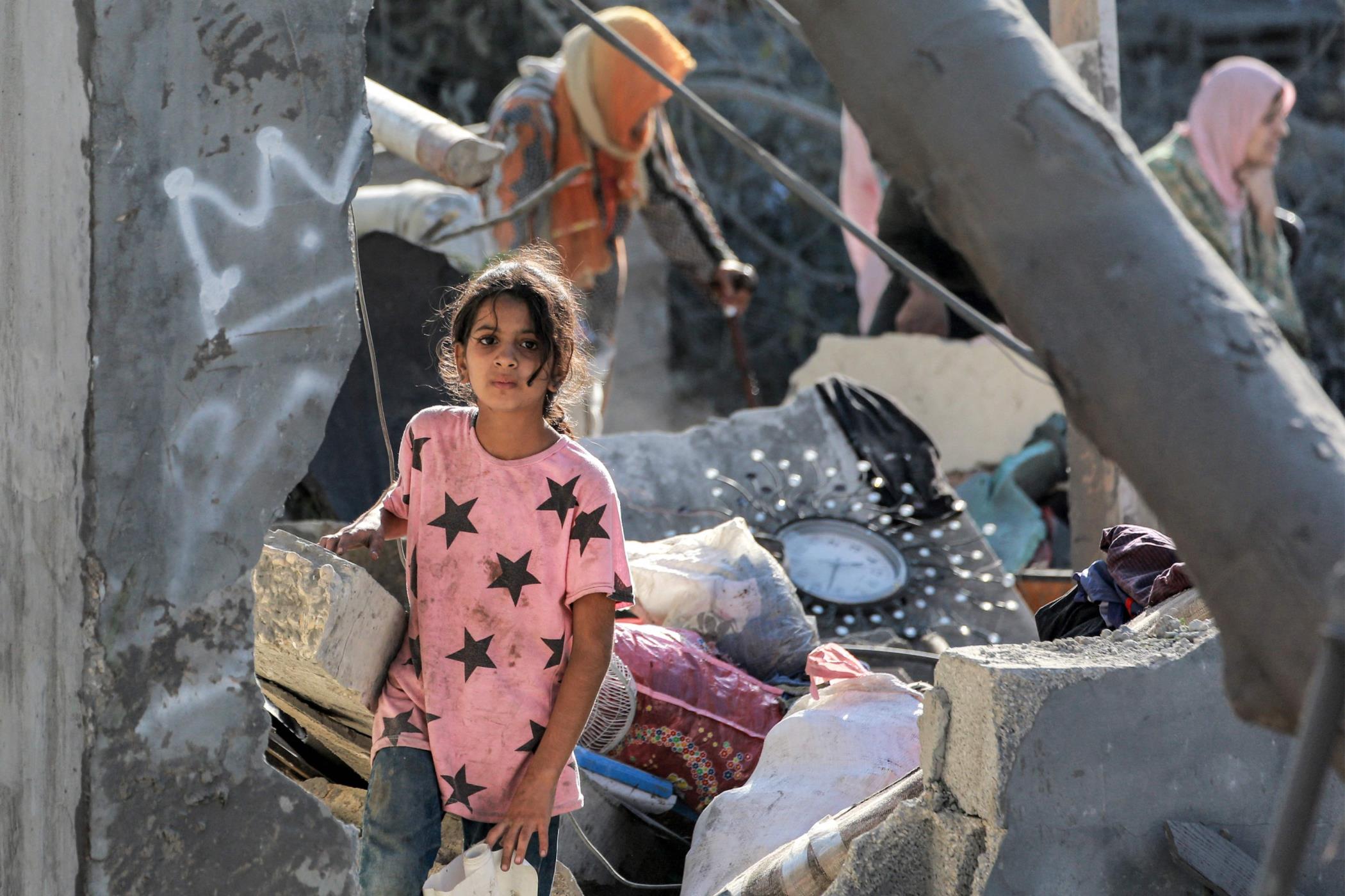 A girl looks on while walking through the rubble of a collapsed building in Khan Younis, southern Gaza Strip, Palestine, Oct. 2, 2024. (AFP Photo)