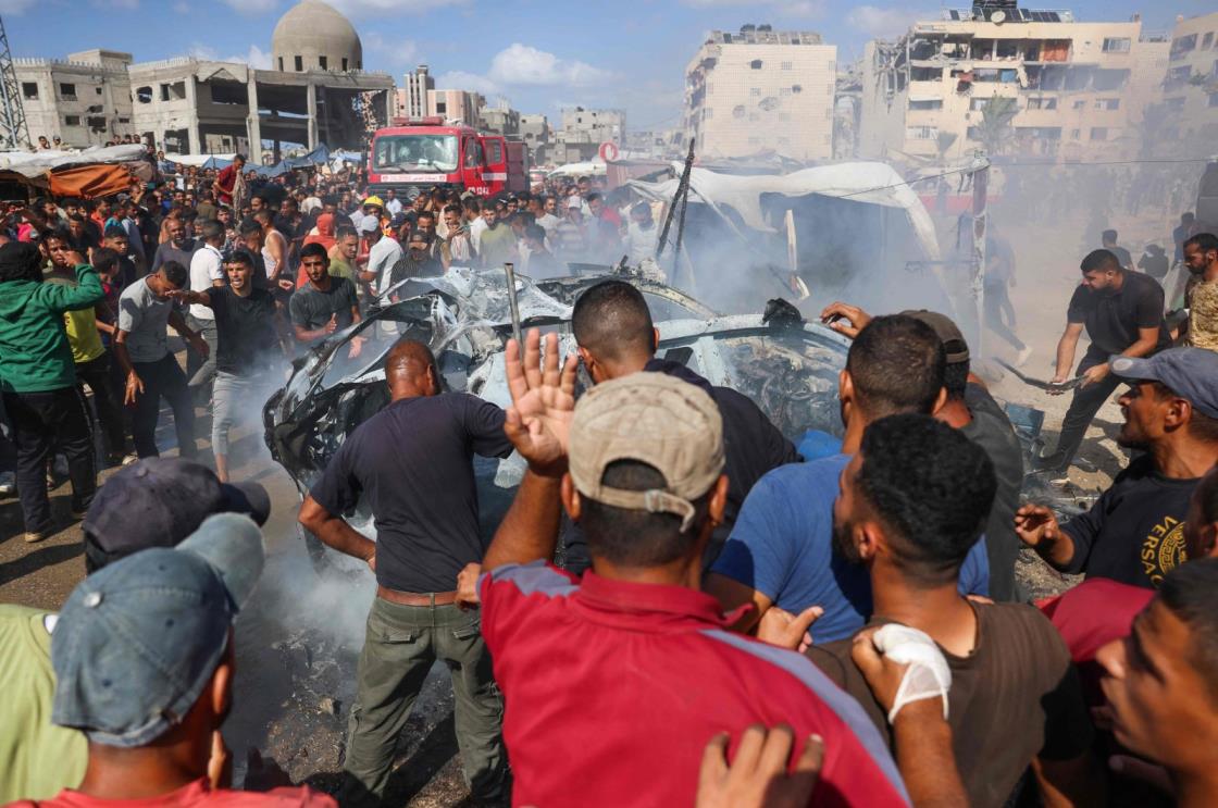 Palestinians douse a burning car with water after it was hit in an Israeli strike in Khan Younis, southern Gaza Strip, Palestine, Oct. 1, 2024. (AFP Photo)