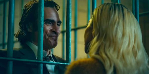 Joaquin Phoenix as Arthur Fleck behind bars receives a visit from Lady Gaga as Harley Quinn in Joker: Folie à Deux