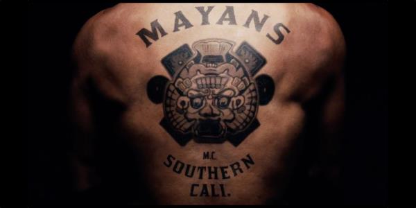 A close-up of a back tattoo of the Mayans M.C. logo