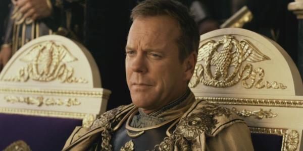 Kiefer Sutherland as Senator Corvus sitting on his gold chair in Pompeii