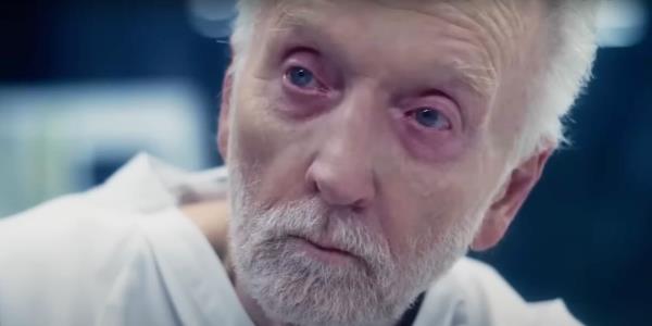 Tobin Bell looks ill in a hospital gown as Jigsaw in Saw X