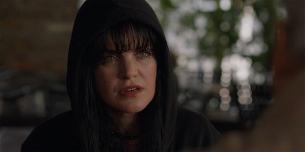 A close up of Abby Sciuto wearing a black hood and looking co<em></em>ncerned in NCIS