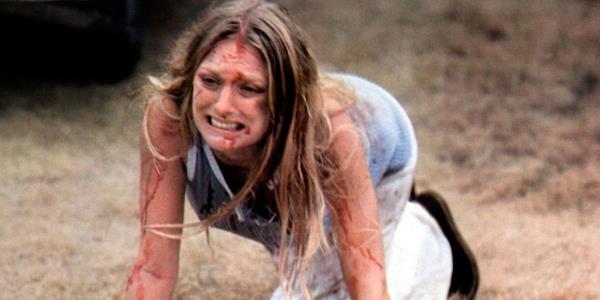 Marilyn Burns as a bloodied Sally Hardesty crawls on the ground in Texas Chain Saw Massacre 1974