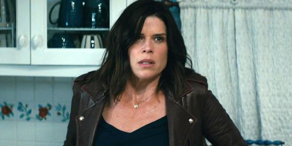 Neve Campbell as Sidney Prescott wearing a brown jacket in Scream 2022