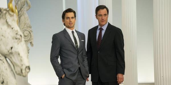 Neal Caffrey (Matt Bomer) and Peter Burke (Tim Dekay) stand together in White Collar.