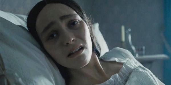 Ellen Hutter (Lily-Rose Depp) in bed looking sick in Nosferatu