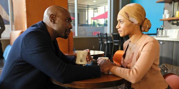 Barrett Cain (Morris Chestnut) holding Rose's (Cara Ricketts) hand as she smiles in The Resident.