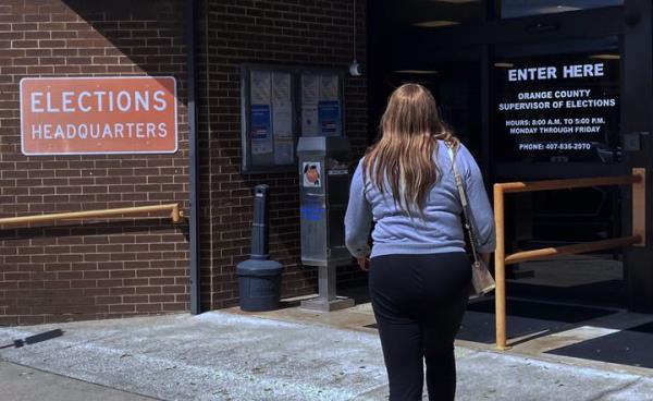 A woman enters the Orange County Supervisor of Elections office on Oct. 17 in Orlando, Florida. In the past four decades, women have turned out to vote at higher rates than men.