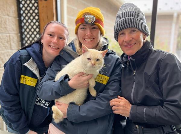 Nan Collins, right, poses with veterinarians and her cat, Ricardo Blanco.