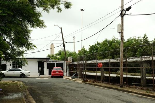 Pipelines run alo<em></em>ngside residential homes in Cata?o, Puerto Rico, a low-income neighborhood in the San Juan metropolitan area.