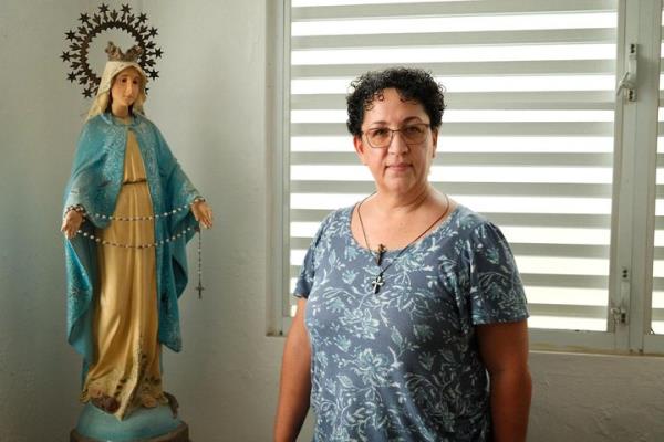 Sister Lissette Avilés Ríos, a nun from the San Juan area, stands in her home near the waterfront she fears is at risk from a natural gas import facility.