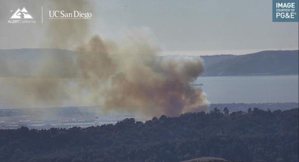 A PG&E camera shows a fast-moving brush fire burning in Oakland, California.