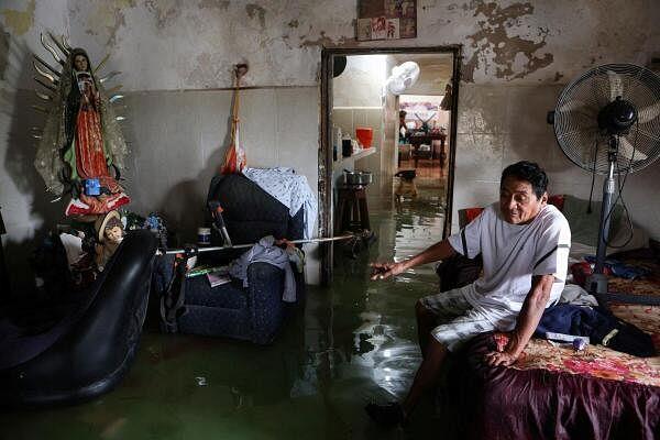 Aurelio Ortiz sits in his flooded home after Hurricane Milton brought heavy rain to Mexico's Yucatan Peninsula on its way to Florida, in Celestun, Mexico