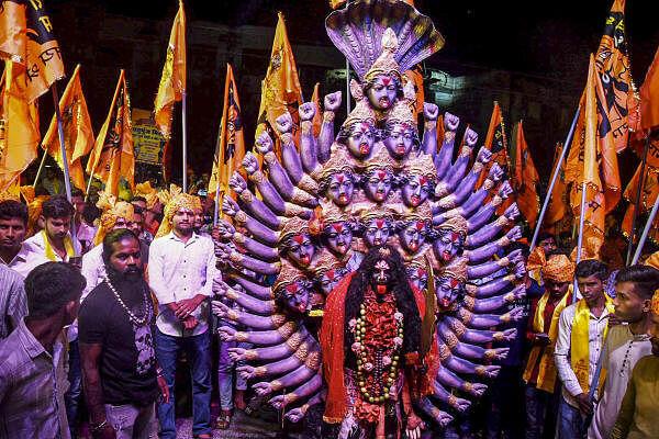 An artist dressed as Goddess Kali performs in a Ram Barat procession during the ‘Navratri’ festival, in Bhopal