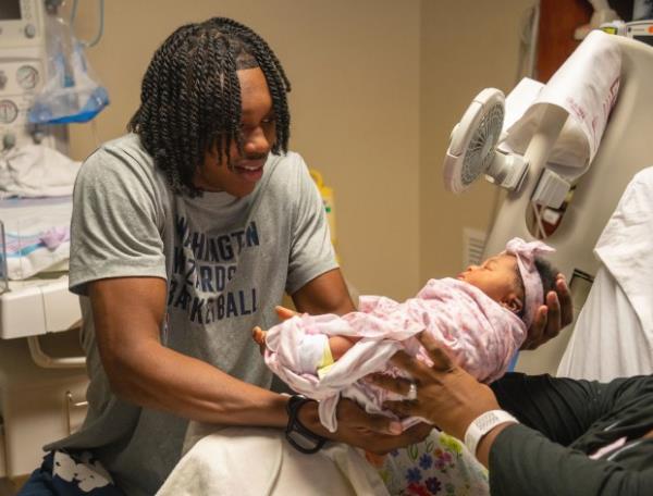 Washington Wizards rookie Carlton "Bub" Carrington, a Baltimore native, visited MedStar Harbor Hospital and held 2-day-old Kalesia, the newborn daughter of Katieba Huddleston, in her room. (Kevin Richardson/Staff)