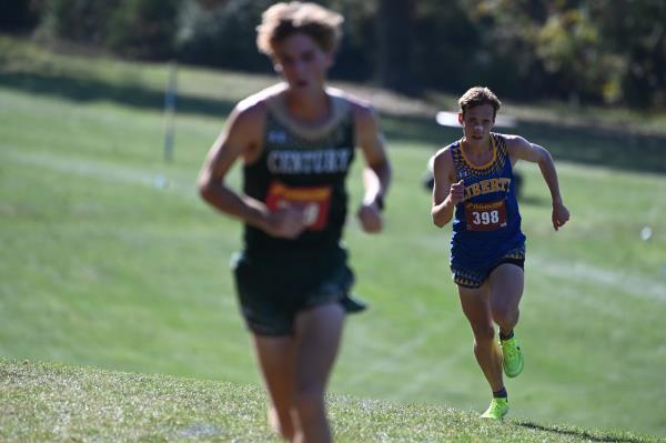 Liberty's Gregory Schellberg look ahead at race leader, Century's Ryan Hartranft, in the boys varsity race during the Carroll County cross country champio<em></em>nships at McDaniel College on Tuesday. (Brian Krista/Staff)