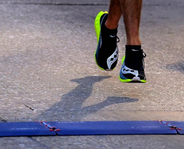 Chad Sussman of Sykesville reaches the finish line while running the marathon during the 24th Annual Running Festival at the inner harbor. (Karl Merton Ferron/Staff)